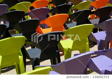rows of colorful plastic chairs and an open-air auditorium rows of colorful plastic chairs and an open-air auditorium 138082331