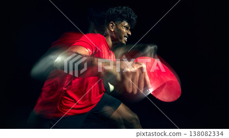 Table tennis player showing frustration during intense gameplay moment with motion blur. Table tennis player showing frustration during intense gameplay moment with motion blur. 138082334