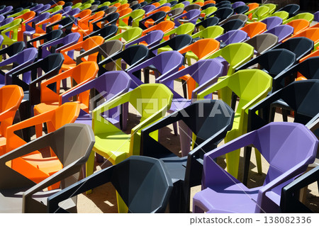 rows of colorful plastic chairs and an open-air auditorium 138082336
