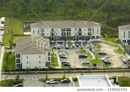 Top view of new apartment condos in Florida suburban area. Family housing in quiet neighborhood. Real estate development in american suburbs Top view of new apartment condos in Florida suburban area. Family housing in quiet neighborhood. Real estate development in american suburbs 138082450