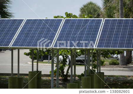 Solar panels installed on stand frame near parking lot for effective generation of clean electricity. Photovoltaic technology integrated in urban infrastructure for electric car charging 138082601