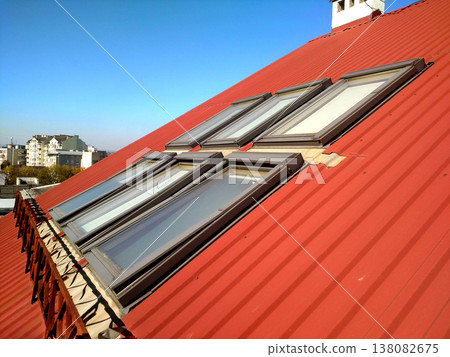 Red tiled house roof with attic windows. Roofing construction, window installation, modern architecture concept. Red tiled house roof with attic windows. Roofing construction, window installation, modern architecture concept. 138082675