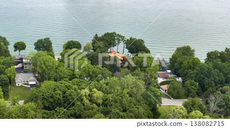 Private residential houses in lakeside suburban sprawl area in Rochester, New York. Upscale suburban homes with large backyard and green grassy lawn in summer season Private residential houses in lakeside suburban sprawl area in Rochester, New York. Upscale suburban homes with large backyard and green grassy lawn in summer season 138082715