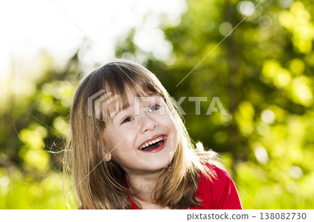 Portrait of happy smiling little girl on sunny summer grass meadow. Portrait of happy smiling little girl on sunny summer grass meadow. 138082730