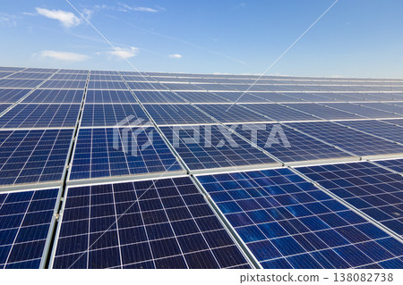 Photovoltaic panels on solar rooftops of commercial building for producing clean ecological electrical energy. Renewable electricity with zero emission concept Photovoltaic panels on solar rooftops of commercial building for producing clean ecological electrical energy. Renewable electricity with zero emission concept 138082738