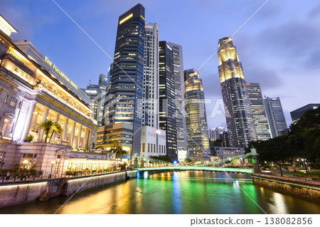 Night view of the Fullerton Hotel, Cavenagh Bridge, and financial district skyscrapers along the Singapore River. Night view of the Fullerton Hotel, Cavenagh Bridge, and financial district skyscrapers along the Singapore River. 138082856