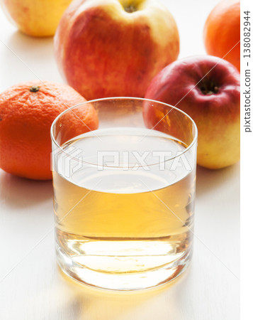 Glass of fresh apple and orange mixed vitamin juice on table with fruits, sweet healthy beverage. 138082944