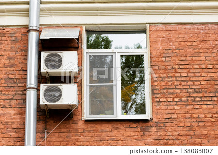 air conditioning on facade of building, air cooling in hot weather.  138083007