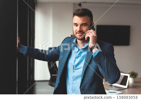 Portrait of a businessman in the office with phone Portrait of a businessman in the office with phone 138083058