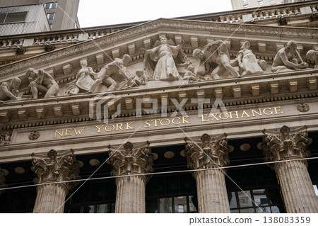 Close view of the New York Stock Exchange sign beneath its sculpted pediment on Wall Street. Classical stone relief figures represent commerce and industry in Manhattan financial district. Close view of the New York Stock Exchange sign beneath its sculpted pediment on Wall Street. Classical stone relief figures represent commerce and industry in Manhattan financial district. 138083359