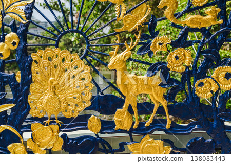 Ornate decorative relief with golden animals and floral patterns at Plai Laem temple Koh Samui 138083443
