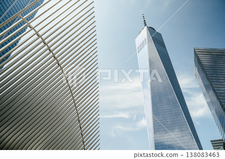One World Trade Center rises beside the curved white structure of the Oculus in Lower Manhattan, New York City. The downtown skyline showcases modern architecture and urban development. One World Trade Center rises beside the curved white structure of the Oculus in Lower Manhattan, New York City. The downtown skyline showcases modern architecture and urban development. 138083463