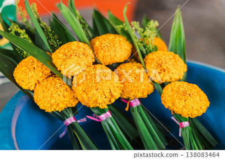 Traditional marigold flower offerings prepared for Buddhist ritual at temple on Koh Samui island in Thailand 138083464