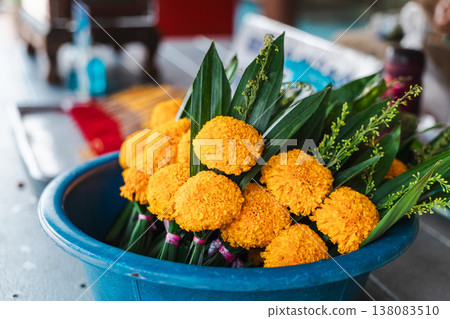 Marigold flower offerings arranged in bowl at Buddhist temple in Thailand Marigold flower offerings arranged in bowl at Buddhist temple in Thailand 138083510