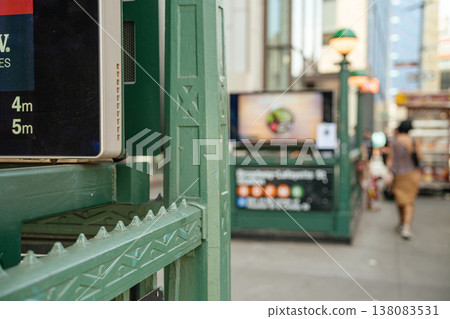 Close up of green metal railing at Broadway Lafayette subway entrance in Manhattan. Shallow depth of field shows New York City urban transportation background. 138083531