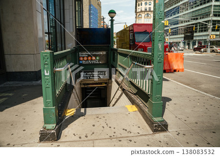 Green subway entrance with stairs leading underground at Broadway Lafayette station in Manhattan. New York City public transportation access at street level. Green subway entrance with stairs leading underground at Broadway Lafayette station in Manhattan. New York City public transportation access at street level. 138083532