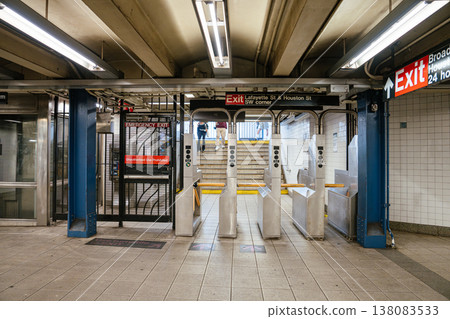 Metal turnstiles and exit gate inside a New York City subway station. Underground metro entrance with security barriers and transportation infrastructure. Metal turnstiles and exit gate inside a New York City subway station. Underground metro entrance with security barriers and transportation infrastructure. 138083533