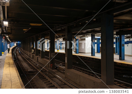 Curved railway tracks at Broadway Lafayette Street subway station in Manhattan. Underground New York City metro platform with yellow safety strip, steel columns, and urban transit infrastructure. Curved railway tracks at Broadway Lafayette Street subway station in Manhattan. Underground New York City metro platform with yellow safety strip, steel columns, and urban transit infrastructure. 138083541