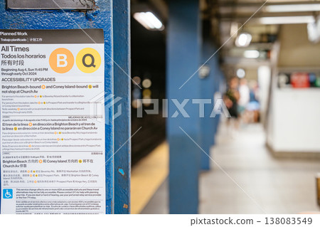 Close up of B and Q train service notice sign at Broadway Lafayette Street subway station in Manhattan. Underground New York City metro platform scene showing transit information, blue steel column 138083549