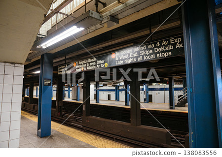 Directional subway sign above the platform at Broadway Lafayette Street station in Manhattan. Underground New York City metro scene with tracks, blue columns, and urban transportation network. 138083556