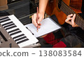 male musician writing a hit song by acoustic guitar in home studio. songwriting concept 138083584