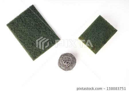 Set of Three Household Kitchen Cleaning Tools Including Two Green Abrasive Scrub Pads, One Dual-Sided Sponge, and One Stainless Steel Wool Ball on White Background Set of Three Household Kitchen Cleaning Tools Including Two Green Abrasive Scrub Pads, One Dual-Sided Sponge, and One Stainless Steel Wool Ball on White Background 138083751