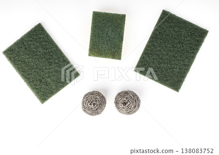 Set of Three Green Nylon Abrasive Scrubbing Pads and Two Stainless Steel Wire Wool Balls for Kitchen Dishwashing and Heavy-Duty Household Cleaning Isolated on White 138083752