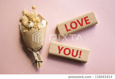 Love you symbol. Wooden blocks with words Love you. Beautiful pink background with bouquet of flowers. Healthcare and Love you concept. Copy space. 138083814