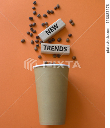 New Trends symbol. Concept word New Trends on wooden blocks. Beautiful orange background with coffee cup. Business and New Trends concept. Copy space New Trends symbol. Concept word New Trends on wooden blocks. Beautiful orange background with coffee cup. Business and New Trends concept. Copy space 138083878