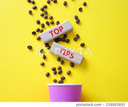 Top Tips symbol. Wooden blocks with words Top Tips. Beautiful yellow background with coffee cup and coffee beans. Business and Top Tips concept. Copy space. Top Tips symbol. Wooden blocks with words Top Tips. Beautiful yellow background with coffee cup and coffee beans. Business and Top Tips concept. Copy space. 138083893