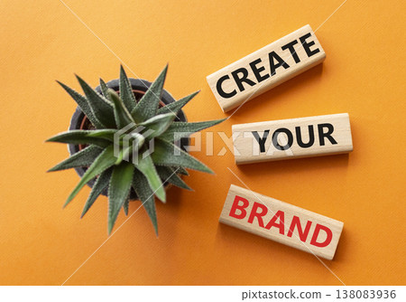 Brand symbol. Concept words Create your Brand on wooden blocks. Businessman hand. Beautiful orange background with succulent. Business and Create your Brand concept. Copy space. Brand symbol. Concept words Create your Brand on wooden blocks. Businessman hand. Beautiful orange background with succulent. Business and Create your Brand concept. Copy space. 138083936
