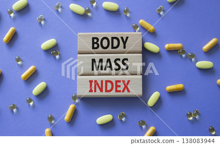 Body Mass Index symbol. Concept word Body Mass Index on wooden blocks. Beautiful purple background with pills. Medicine and Body Mass Index concept. Copy space Body Mass Index symbol. Concept word Body Mass Index on wooden blocks. Beautiful purple background with pills. Medicine and Body Mass Index concept. Copy space 138083944