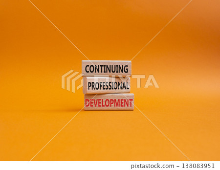 Continuing Development symbol. Concept words Continuing Professional Development on wooden blocks. Beautiful orange background. Business and Development concept. Copy space 138083951