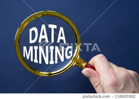Data Mining symbol. Magnifying Glass with words Data Mining. Beautiful dark blue background. Businessman hand. Business and Data Mining concept. Copy space. 138083982