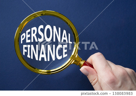 Personal Finance symbol. Magnifying Glass with words Personal Finance. Businessman hand. Beautiful deep blue background. Business and Personal Finance concept. Copy space. 138083983