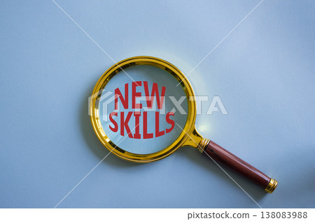 New skills symbol. Magnifying Glass with Concept word New skills. Beautiful blue background. Business and New skills concept. Copy space 138083988