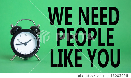 Hiring symbol. Wooden blocks with words We need People like You. Beautiful green background with alarm clock. Business and Hiring concept. Copy space. 138083996
