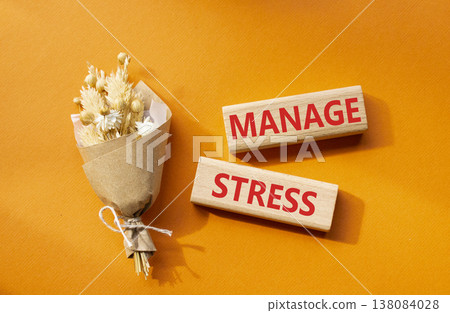 Manage stress symbol. Concept word Manage stress on wooden blocks. Beautiful orange background with bouquet of flowers. Business and Manage stress concept. Copy space 138084028