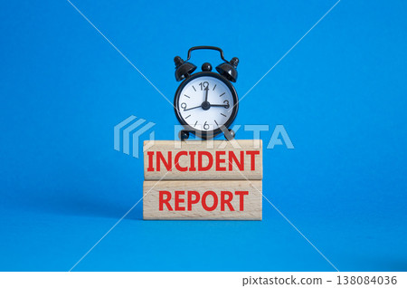 Incident Report symbol. Concept word Incident Report on wooden blocks. Beautiful blue background with alarm clock. Business and Incident Report concept. Copy space 138084036