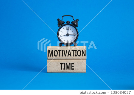 Motivation Time symbol. Concept word Motivation Time on wooden blocks. Beautiful blue background with alarm clock. Business and Motivation Time concept. Copy space Motivation Time symbol. Concept word Motivation Time on wooden blocks. Beautiful blue background with alarm clock. Business and Motivation Time concept. Copy space 138084037