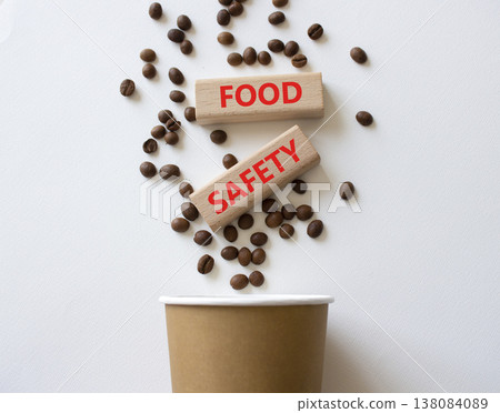 Food Safety symbol. Concept words Food Safety on beautiful wooden picture frame. Beautiful white background with coffee cup and coffee beans. Business and Food Safety concept. Copy space. Food Safety symbol. Concept words Food Safety on beautiful wooden picture frame. Beautiful white background with coffee cup and coffee beans. Business and Food Safety concept. Copy space. 138084089