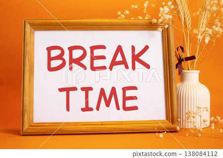Break Time symbol. Concept words Break Time on beautiful wooden picture frame. Beautiful orange background with flower vase. Business and Break Time concept. Copy space. Break Time symbol. Concept words Break Time on beautiful wooden picture frame. Beautiful orange background with flower vase. Business and Break Time concept. Copy space. 138084112