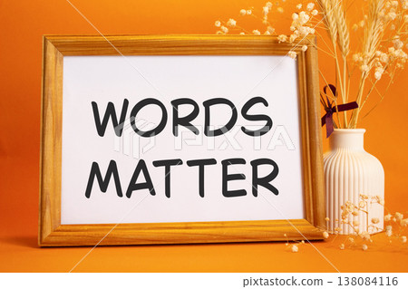 Words Matter symbol. Concept words Words Matter on beautiful wooden picture frame. Beautiful orange background with flower vase. Business and Words Matter concept. Copy space. 138084116