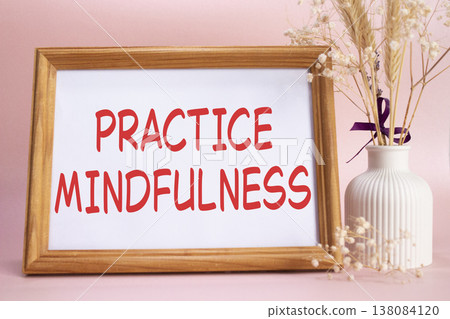 Mindfulness symbol. Concept words Practice Mindfulness on beautiful wooden picture frame. Beautiful pink background with flower vase. Medical and Psychology concept. Copy space. Mindfulness symbol. Concept words Practice Mindfulness on beautiful wooden picture frame. Beautiful pink background with flower vase. Medical and Psychology concept. Copy space. 138084120