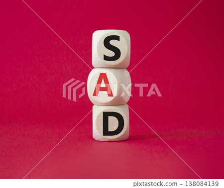 Sad symbol. Wooden cubes with words Sad. Beautiful red background. Business and Sad concept. Copy space. 138084139
