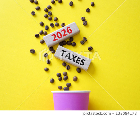 2026 Taxes symbol. Concept words 2026 Taxes on beautiful wooden picture frame. Beautiful yellow background with coffee cup and coffee beans. Business and 2026 Taxes concept. Copy space. 2026 Taxes symbol. Concept words 2026 Taxes on beautiful wooden picture frame. Beautiful yellow background with coffee cup and coffee beans. Business and 2026 Taxes concept. Copy space. 138084178