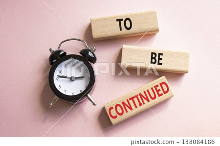 To be continued symbol. Concept words To be continued on wooden blocks. Beautiful pink background with alarm clock. Business concept and To be continued. Copy space. To be continued symbol. Concept words To be continued on wooden blocks. Beautiful pink background with alarm clock. Business concept and To be continued. Copy space. 138084186