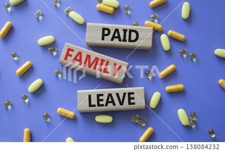 Paid Family Leave symbol. Concept words Paid Family Leave on wooden blocks. Beautiful purple background with pills. Healthcare and Paid Family Leave concept. Copy space. 138084232