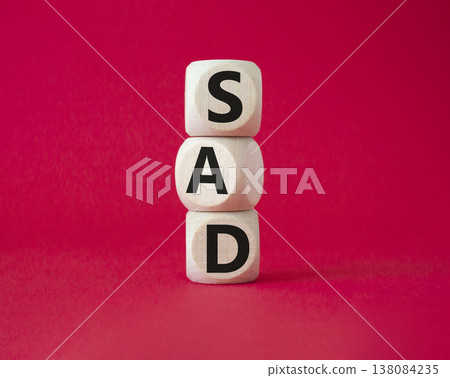 Sad symbol. Wooden cubes with words Sad. Beautiful red background. Business and Sad concept. Copy space. Sad symbol. Wooden cubes with words Sad. Beautiful red background. Business and Sad concept. Copy space. 138084235