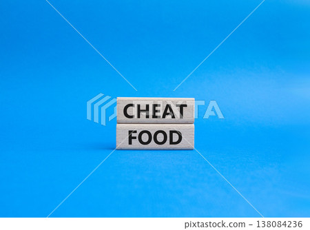 Cheat Food symbol. Wooden blocks with words Cheat Food. Beautiful blue background. Health and Cheat Food concept. Copy space. 138084236